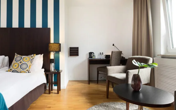 Rum med skrivbord, stol och sittgrupp vid fönster